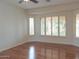 A bright bedroom features hardwood floors and shuttered windows at 13417 W La Vina Dr, Sun City West, AZ 85375