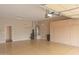 Spacious garage with painted floor, utility sink, water heater and lots of storage cabinets at 13417 W La Vina Dr, Sun City West, AZ 85375