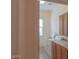 Bright laundry area featuring side-by-side washer and dryer, cabinets, and a window for natural light at 13417 W La Vina Dr, Sun City West, AZ 85375