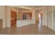 Open concept living room boasts kitchen views and natural light from shuttered windows at 13417 W La Vina Dr, Sun City West, AZ 85375