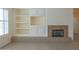 Cozy living room features a fireplace with built-in cabinets and shelving at 13417 W La Vina Dr, Sun City West, AZ 85375