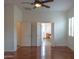 Spacious main bedroom featuring a ceiling fan, hardwood floors, and connecting bath at 13417 W La Vina Dr, Sun City West, AZ 85375