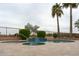 Backyard pool and spa with waterfall feature surrounded by travertine deck at 13417 W La Vina Dr, Sun City West, AZ 85375