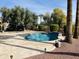 Backyard pool and spa surrounded by travertine deck and mature trees at 13417 W La Vina Dr, Sun City West, AZ 85375