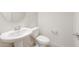 Powder room featuring modern pedestal sink and efficient toilet at 13803 W Calle De Baca --, Peoria, AZ 85383