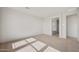 An airy bedroom with neutral carpet and view into the ensuite bathroom at 13803 W Calle De Baca --, Peoria, AZ 85383