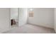 Bright bedroom featuring neutral carpet and a window, with a bathroom view at 13803 W Calle De Baca --, Peoria, AZ 85383