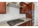 Contemporary kitchen with stainless steel hood vent, granite countertops, and gas range at 13803 W Calle De Baca --, Peoria, AZ 85383