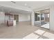 Bright, open-concept living area with tiled floor, kitchen island, and sliding glass doors to the patio at 13803 W Calle De Baca --, Peoria, AZ 85383