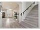 Inviting entryway with hardwood floors and stairs leading to the second level at 1554 E Stirrup Ct, Gilbert, AZ 85296