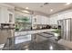 Bright kitchen with white cabinets, stainless steel appliances, and a large window at 1554 E Stirrup Ct, Gilbert, AZ 85296