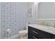 Stylish powder room with blue patterned wallpaper and a modern vanity with gold hardware at 1554 E Stirrup Ct, Gilbert, AZ 85296