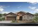 Charming single-story home featuring a two-car garage, stone accents and a tile roof at 17131 W Oberlin Way, Surprise, AZ 85387