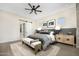 Comfortable bedroom with a ceiling fan, barn door to closet and neutral decor at 17434 W Via Dona Rd, Surprise, AZ 85387