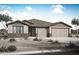 Charming single-story home with a three-car garage and desert landscaping at 17434 W Via Dona Rd, Surprise, AZ 85387