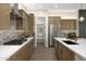 Well-equipped kitchen boasts stainless appliances, ample counter space, and a pantry for organized storage at 17434 W Via Dona Rd, Surprise, AZ 85387