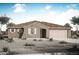 Charming single-story home with a tile roof, desert landscaping, and an attached two-car garage at 17450 W Via Dona Rd, Surprise, AZ 85387