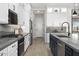 Modern kitchen with stainless steel appliances, granite countertops, and island with a sink at 17450 W Via Dona Rd, Surprise, AZ 85387