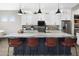 Bright kitchen featuring a large island with seating, modern lighting, and plenty of countertop space at 17450 W Via Dona Rd, Surprise, AZ 85387
