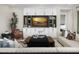 Cozy living room with modern decor, built-in cabinets, comfortable seating, and a stylish coffee table at 17450 W Via Dona Rd, Surprise, AZ 85387