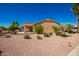 The house features desert landscaping and covered patio offers shade and space for outdoor enjoyment at 1822 N 164Th Dr # 58, Goodyear, AZ 85395