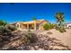 Desert landscaping and a covered patio provide shade and space for outdoor relaxation at 1822 N 164Th Dr # 58, Goodyear, AZ 85395