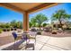 Charming outdoor seating on the covered patio offers a relaxing view of the well maintained yard at 1822 N 164Th Dr # 58, Goodyear, AZ 85395