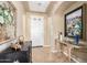 Welcoming foyer with tile floors, neutral walls, elegant furnishings, and a tray ceiling at 1822 N 164Th Dr # 58, Goodyear, AZ 85395