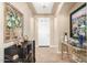 Inviting foyer featuring tile floors, neutral walls, elegant furnishings, and a tray ceiling at 1822 N 164Th Dr # 58, Goodyear, AZ 85395