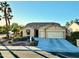 Well-manicured home featuring desert landscaping, a stone facade, and a spacious three-car garage at 1822 N 164Th Dr # 58, Goodyear, AZ 85395