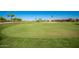 Scenic golf course featuring a well-maintained green, complemented by mature trees and manicured landscaping for relaxed recreation at 1822 N 164Th Dr # 58, Goodyear, AZ 85395