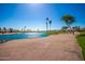 Beautiful golf course with a tranquil lake, swaying palm trees, and verdant green grass, creating a peaceful and inviting atmosphere at 1822 N 164Th Dr # 58, Goodyear, AZ 85395
