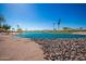 Scenic golf course featuring a tranquil lake, lush landscaping, and clear blue sky, providing a serene backdrop for recreation at 1822 N 164Th Dr # 58, Goodyear, AZ 85395