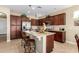 Spacious kitchen with granite countertops, tile floors, stainless steel appliances, and a large center island at 1822 N 164Th Dr # 58, Goodyear, AZ 85395