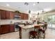 Spacious kitchen features granite countertops, stainless steel appliances, and a breakfast bar with pendant lighting at 1822 N 164Th Dr # 58, Goodyear, AZ 85395