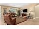 Comfortable living room features plush seating, a large TV, and elegant decor, bathed in natural light at 1822 N 164Th Dr # 58, Goodyear, AZ 85395