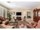 Inviting living room with plush seating, a large TV, and elegant decor, bathed in natural light at 1822 N 164Th Dr # 58, Goodyear, AZ 85395
