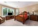 The main bedroom has a large bed, and a sitting area next to a window at 1822 N 164Th Dr # 58, Goodyear, AZ 85395