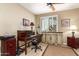 Cozy home office with built-in storage, neutral paint, a ceiling fan, and window with shutters at 1822 N 164Th Dr # 58, Goodyear, AZ 85395