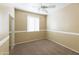 A neutral carpeted bedroom featuring a ceiling fan, window, and mirrored closet at 18342 W La Mirada Dr, Goodyear, AZ 85338