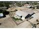 Aerial view of a backyard featuring a covered patio, well-maintained lawn, and desert landscape at 18637 E Flintlock Dr, Queen Creek, AZ 85142