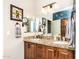 Bathroom featuring granite counters, dual sinks, and attractive wood cabinets at 18637 E Flintlock Dr, Queen Creek, AZ 85142
