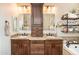 Bright bathroom showcasing double sinks with granite countertops and custom cabinet storage at 18637 E Flintlock Dr, Queen Creek, AZ 85142