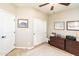 Comfortable bedroom featuring a ceiling fan, closet, and warm, neutral paint at 18637 E Flintlock Dr, Queen Creek, AZ 85142