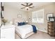 Comfortable bedroom showcasing a ceiling fan, a window with shutters, and neutral-colored walls at 18637 E Flintlock Dr, Queen Creek, AZ 85142