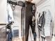 Organized closet with custom built-in shelving and a closet door with hooks for coats and hats at 18637 E Flintlock Dr, Queen Creek, AZ 85142