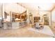 Open concept dining room showcasing a wooden table, island seating, and modern pendant lighting at 18637 E Flintlock Dr, Queen Creek, AZ 85142