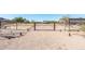 View of the gated driveway leading to the property featuring mature desert landscaping at 18637 E Flintlock Dr, Queen Creek, AZ 85142