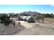 Aerial view of a charming single-story home, showcasing its well-maintained exterior and beautiful mountain views at 18637 E Flintlock Dr, Queen Creek, AZ 85142