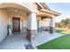 Inviting covered porch with stone pillars, a stylish front door, and an outdoor seating area at 18637 E Flintlock Dr, Queen Creek, AZ 85142